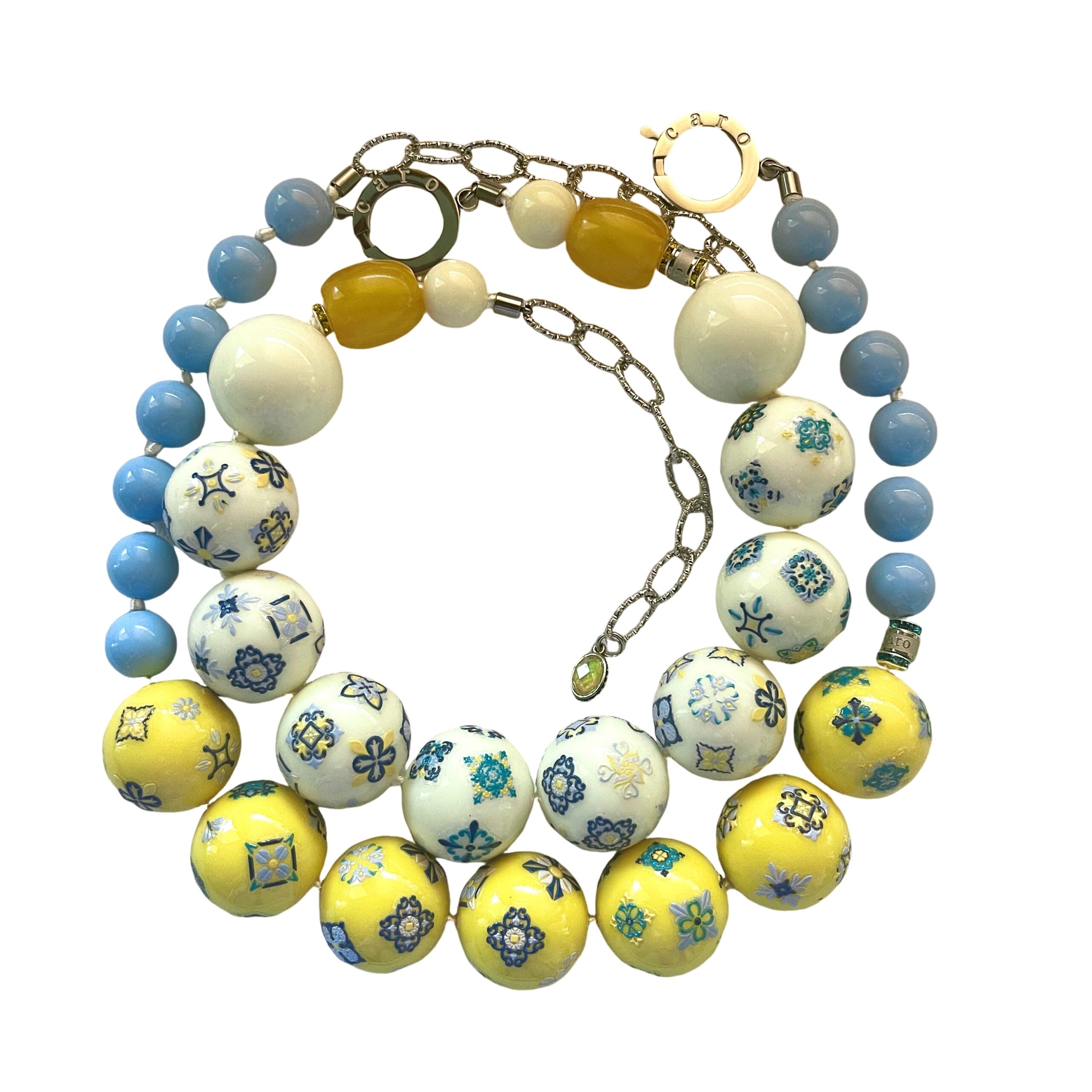 Two‑strand acrylic bead necklace set featuring Egyptian tile motifs in off‑white and yellow tones, displayed on a white background.