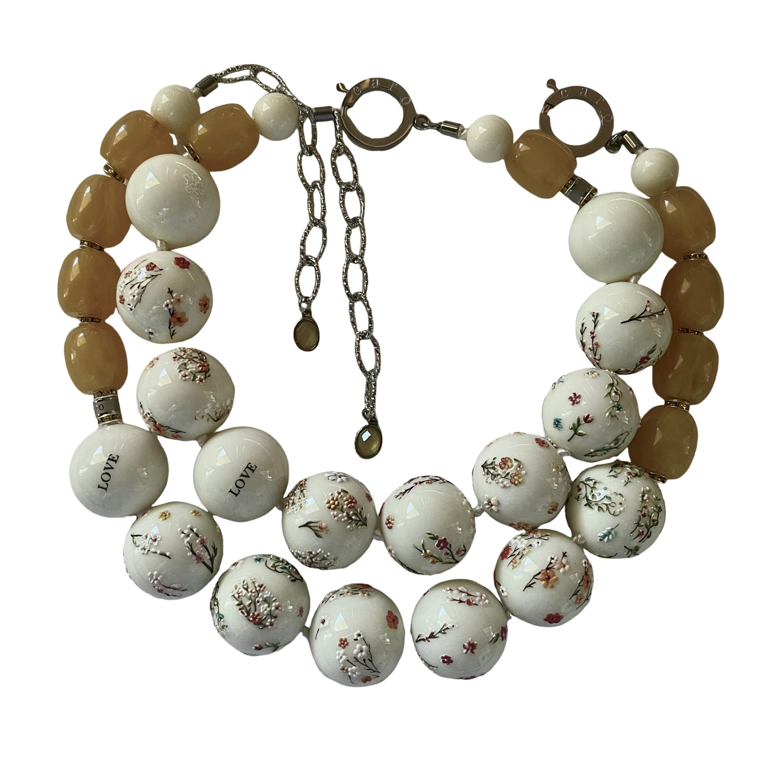 Two‑strand acrylic bead necklace set with floral designs and beeswax‑diluted yellow beads displayed on a black mannequin.