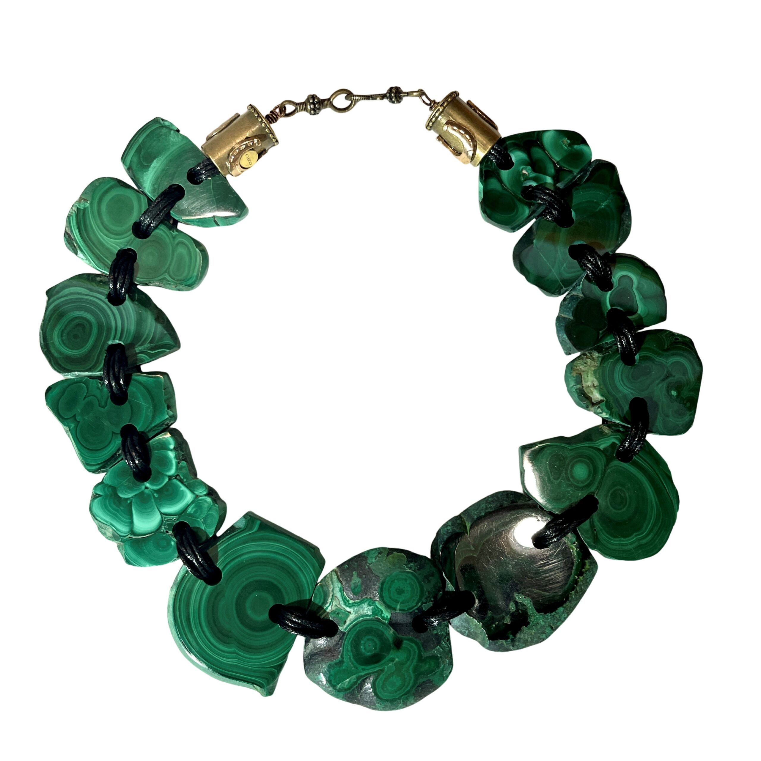 Raw malachite slab necklace with natural green banding linked by cord.